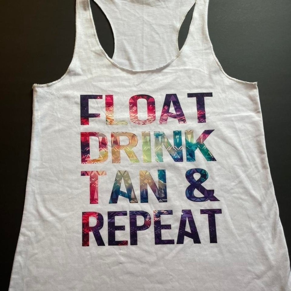 White and multi-coloured "float, drink, tan, and repeat" tank top